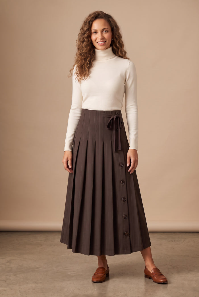 Dark brown pinstripe pleated maxi skirt, front buttons and tied waist detail, worn