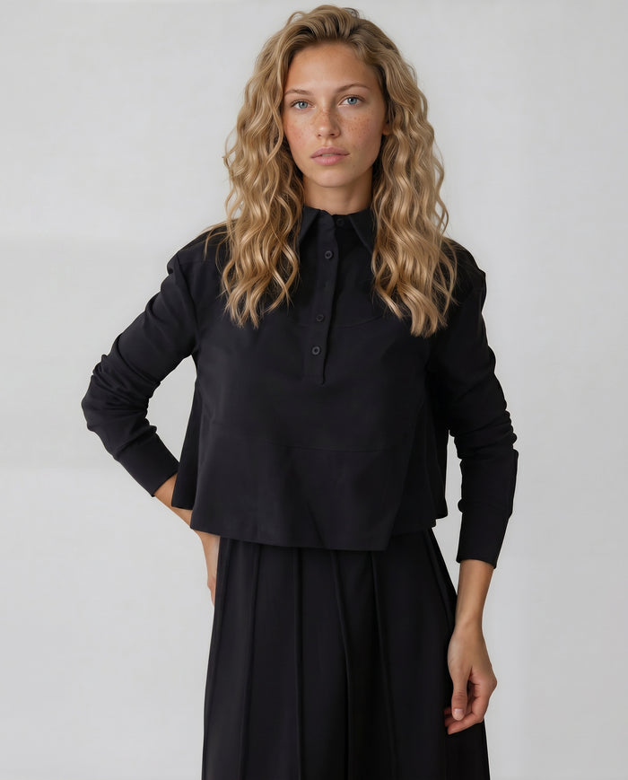 Long sleeve black jersey half button cropped collar shirt with pockets.