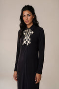 Long sleeve black button down jersey maxi dress with collar and checkered neck scarf tie bow.