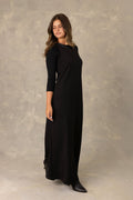 Black jersey sleeveless maxi dress with  tonal trimmed v-neckline.
