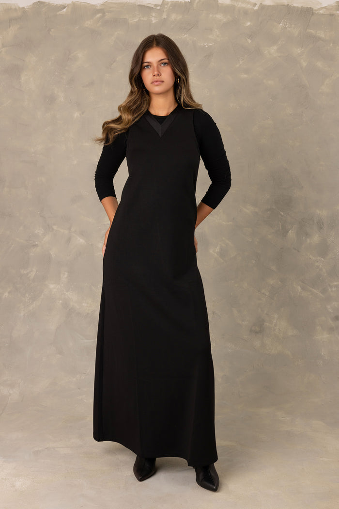 Black jersey sleeveless maxi dress with  tonal trimmed v-neckline.