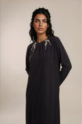 Black long sleeve maxi dress with crystal leaf applique.