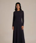 Long sleeve black maxi dress with diagonal cut seams.