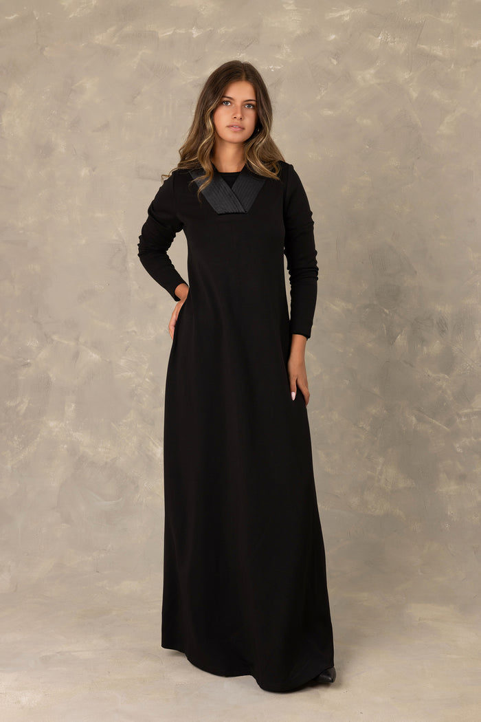 Black long sleeve velvet maxi dress with pleated v-neck insert.