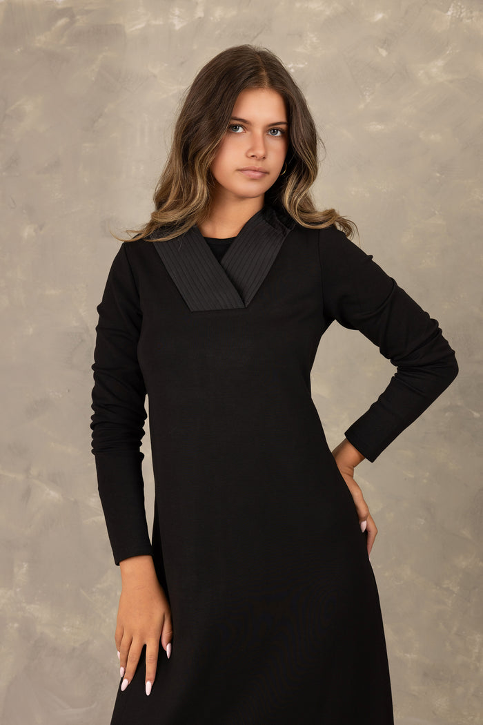 Black long sleeve velvet maxi dress with pleated v-neck insert.