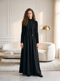 Black long-sleeve ribbed zip cardigan over flowing black maxi jumper dress