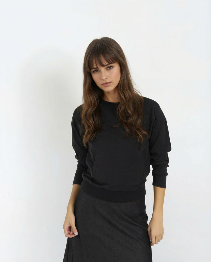 Black dolman-sleeve sweatshirt with ribbed cuffs and ribbed hem, front view on model