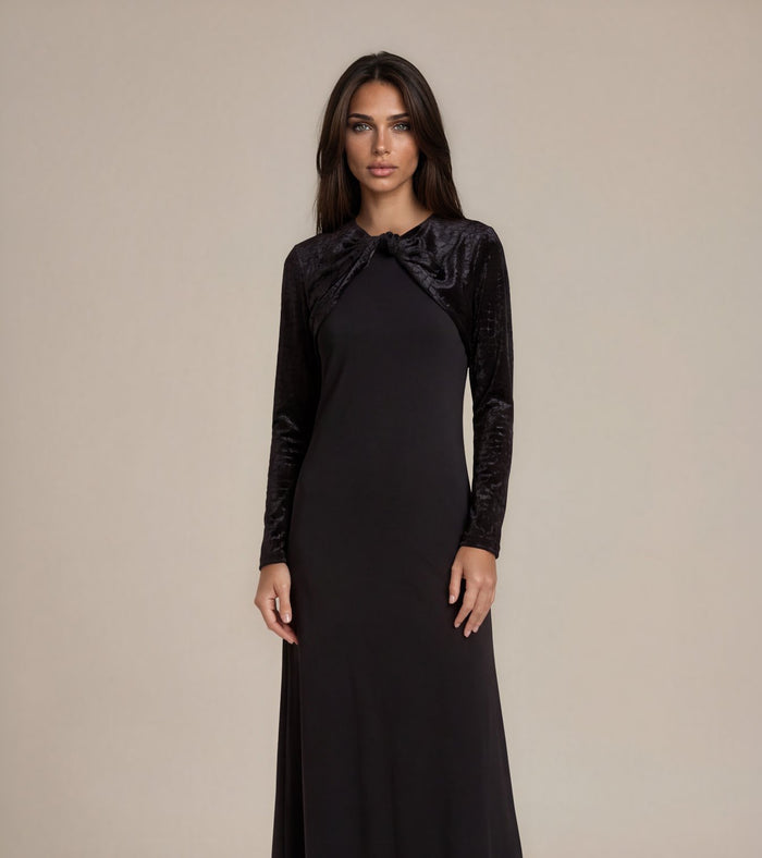 Black velvet maxi dress with bow detail at neckline, long sleeves, fitted silhouette