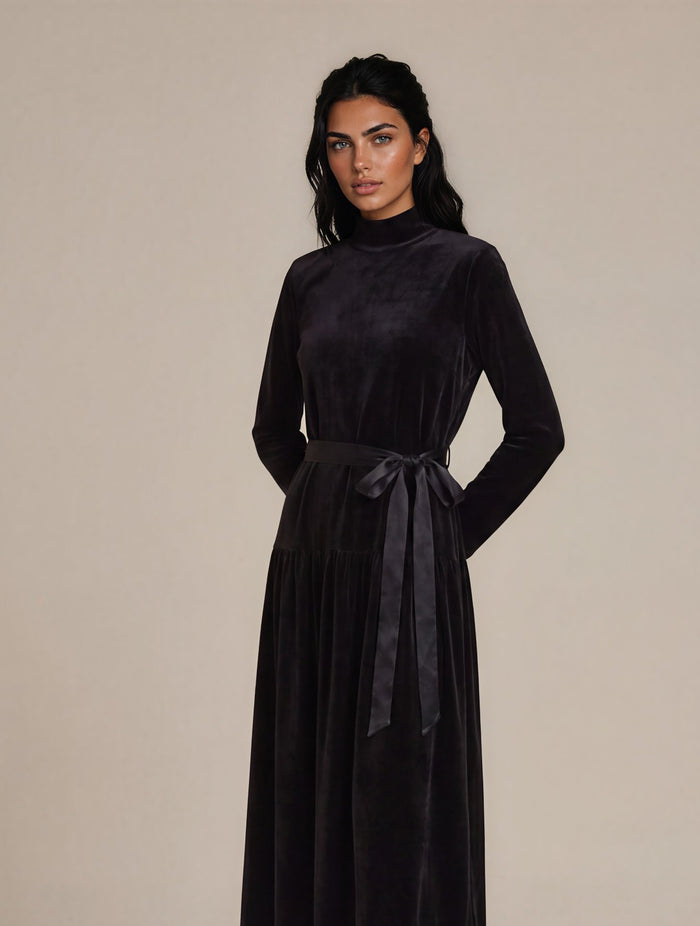 Black long sleeve velour maxi dress with ribbon sash and mock turtleneck collar.