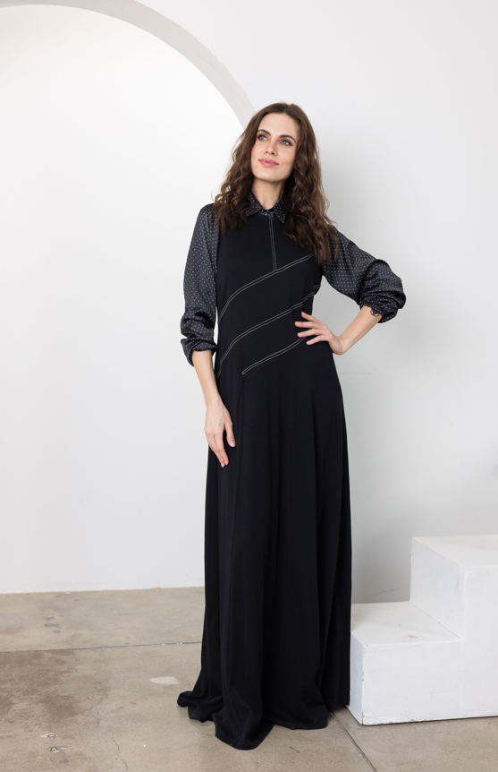 Dark navy line jumper with high neck, long balloon sleeves, and light piping seams