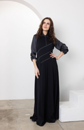 Dark navy line jumper with high neck, long balloon sleeves, and light piping seams