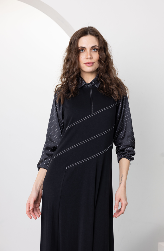Dark navy jumper with high neck, long sleeves, dotted cuffs, and light diagonal piping