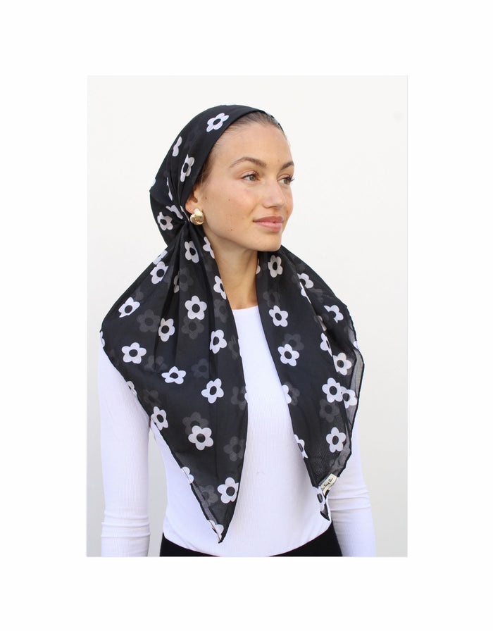 Pre-tied boho headscarf, black with white daisy pattern, worn on head