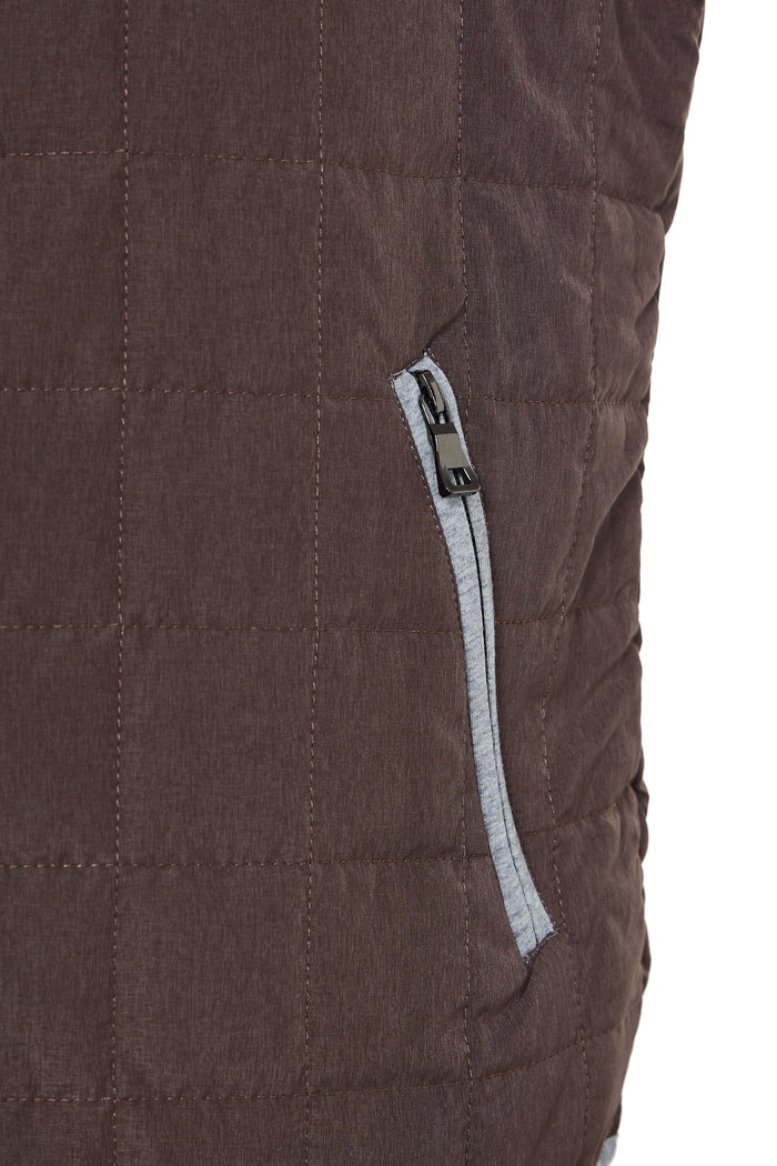 Close-up of a brown quilted jacket with a zipper detail on a white background
