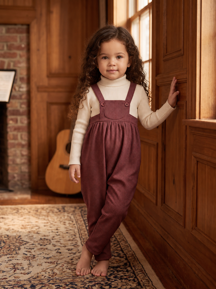 Burgundy tweed baby romper with button straps and pocket.
