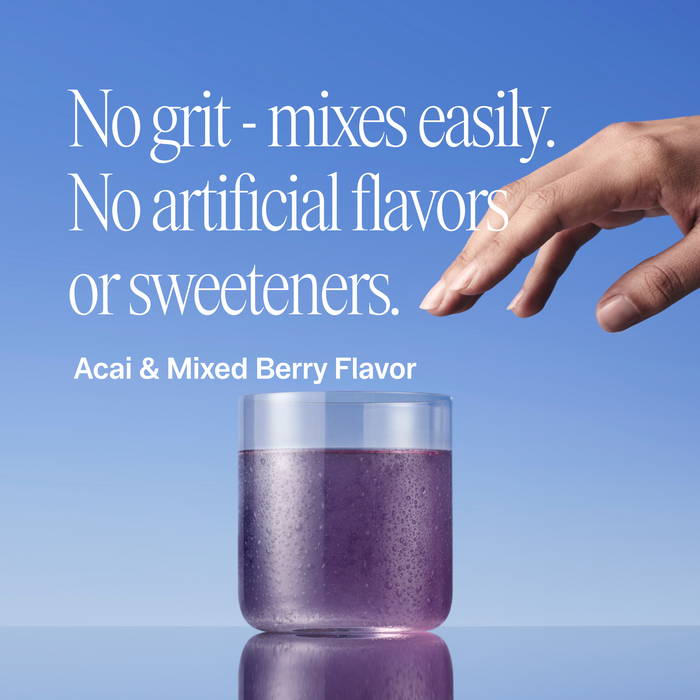Glass of creatine with text about no grit, artificial flavors, or sweeteners on a blue background