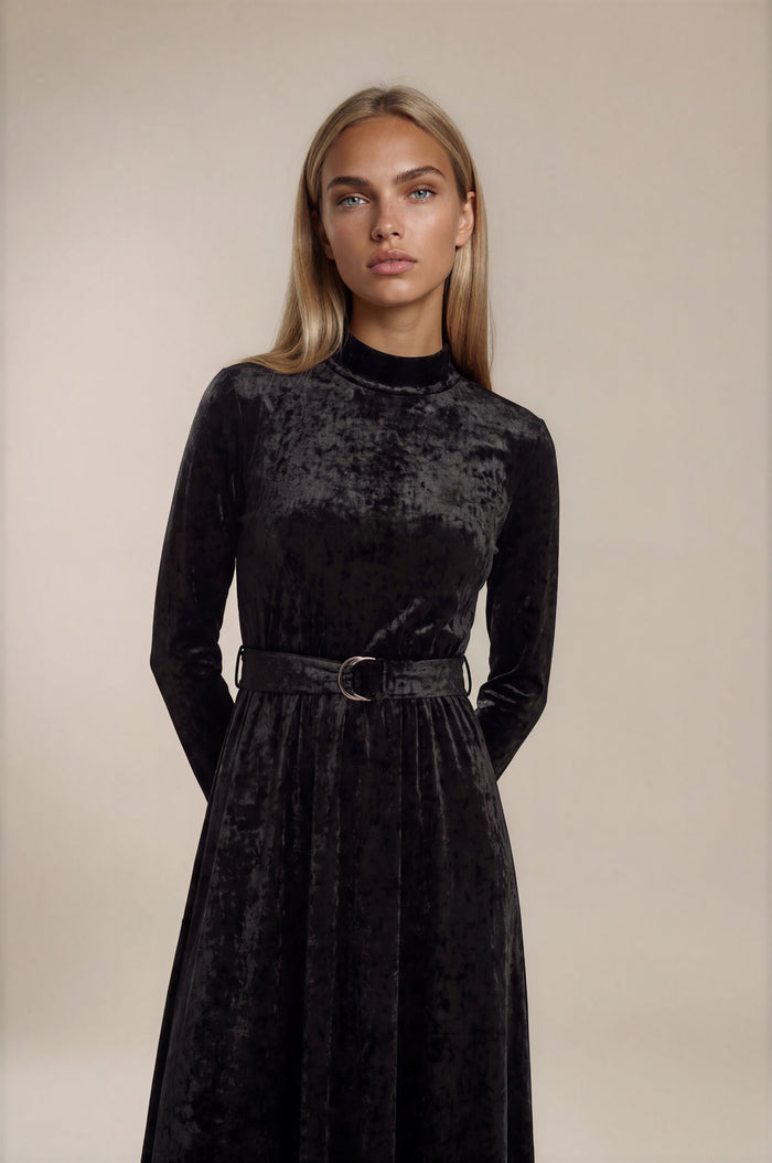 Black crushed velvet long sleeve maxi dress with mock turtle neck collar and metal loop self belt.