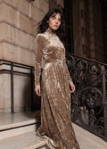 Beige crushed velvet long sleeve maxi dress with mock turtle neck collar and metal loop self belt.