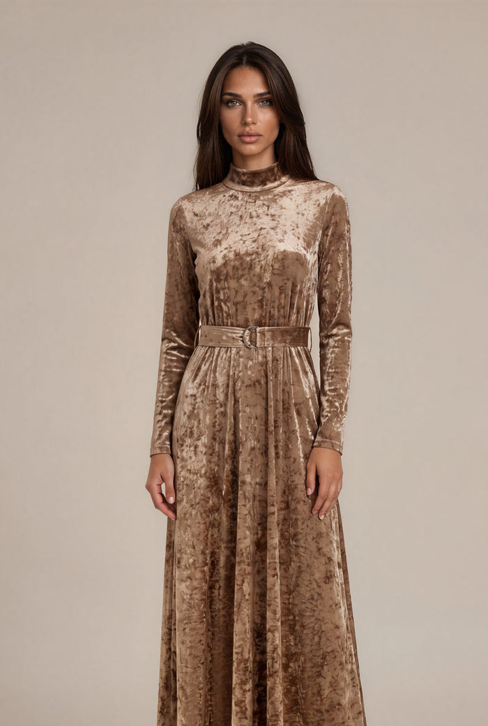 Beige crushed velvet long sleeve maxi dress with mock turtle neck collar and metal loop self belt.