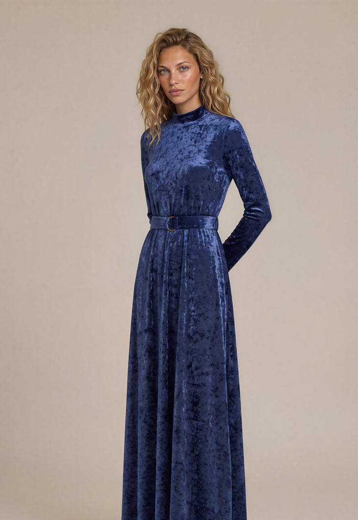 Navy crushed velvet long sleeve maxi dress with mock turtle neck collar and metal loop self belt.