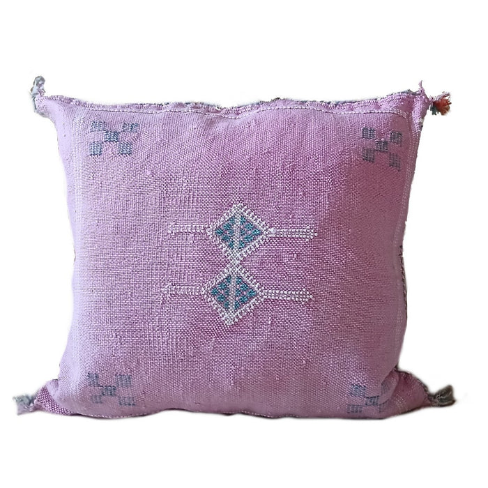 Pink pillow with decorative stitching on a white background