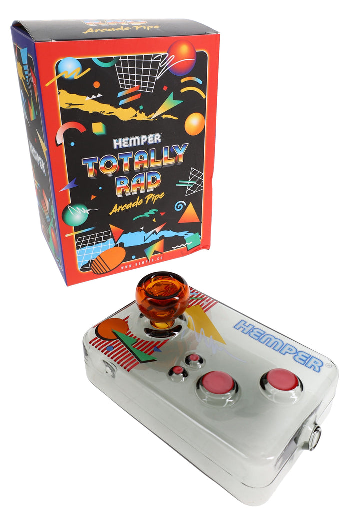 Hemper Totally Rad arcade controller glass hand pipe displayed in front of its colorful retro game box packaging on a white backdrop.