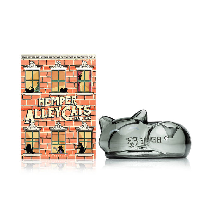 Front view of Hemper Alley Cats hand pipe beside colorful brick-theme box, highlighting the smoky gray sleeping cat glass design.