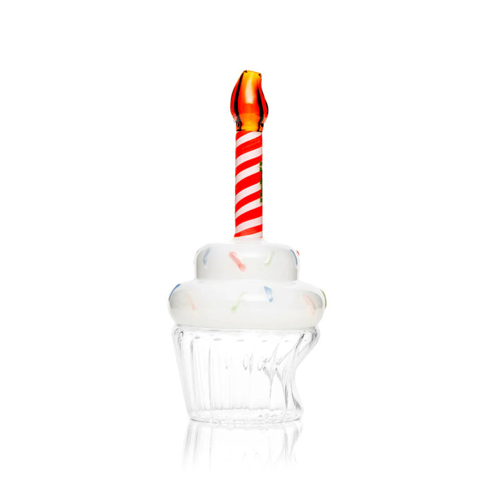 Side view of cupcake glass hand pipe with clear base, frosted top, and red-and-white candle stem