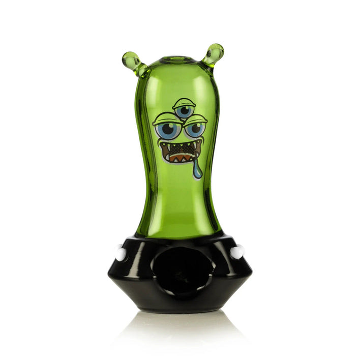 Front view of green space monster hand pipe with black base, white dots, and alien face graphic