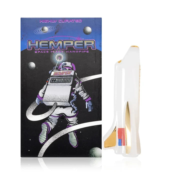 Hemper space shuttle glass hand pipe beside retail box with white shuttle body and gold details
