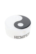 Top angle of Hemper Yin Yang puck glass hand pipe, glossy black-and-white symbol over opaque white base