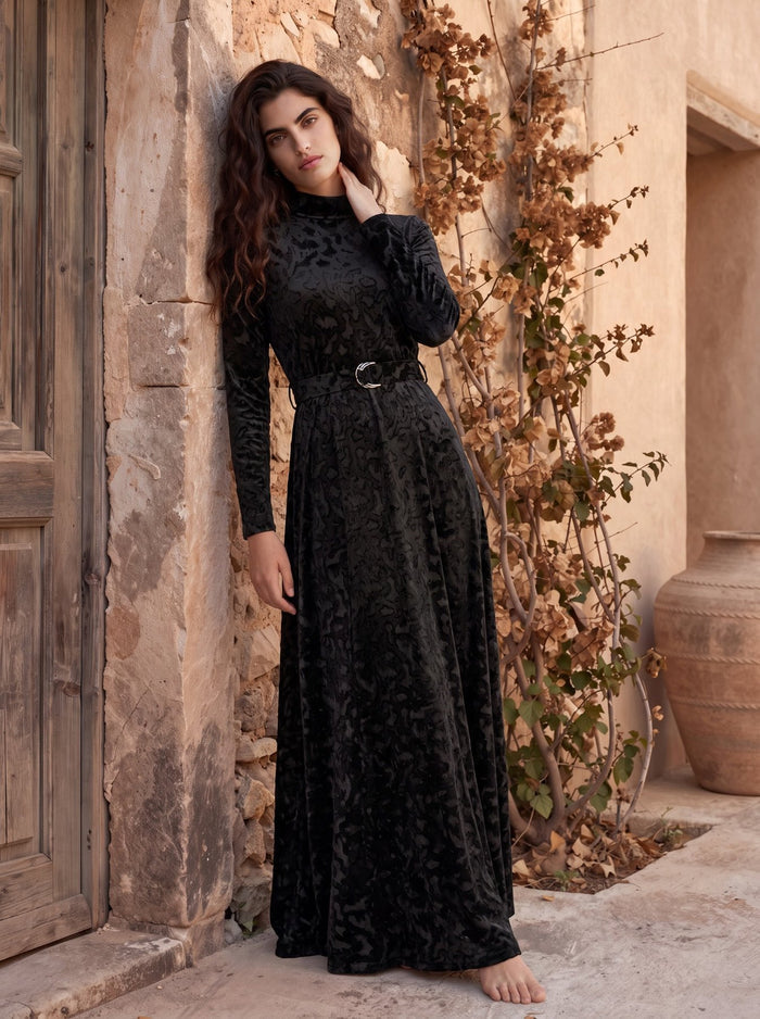 Black patterned velvet long sleeve maxi dress with mock turtle neck collar and metal loop self belt.