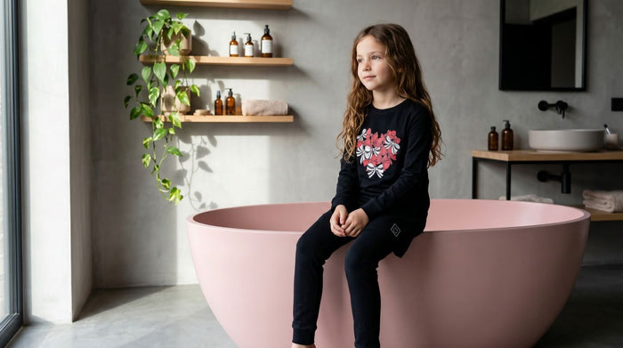 Kids tunic set: black long-sleeve top with bow-heart graphic, paired with dark leggings