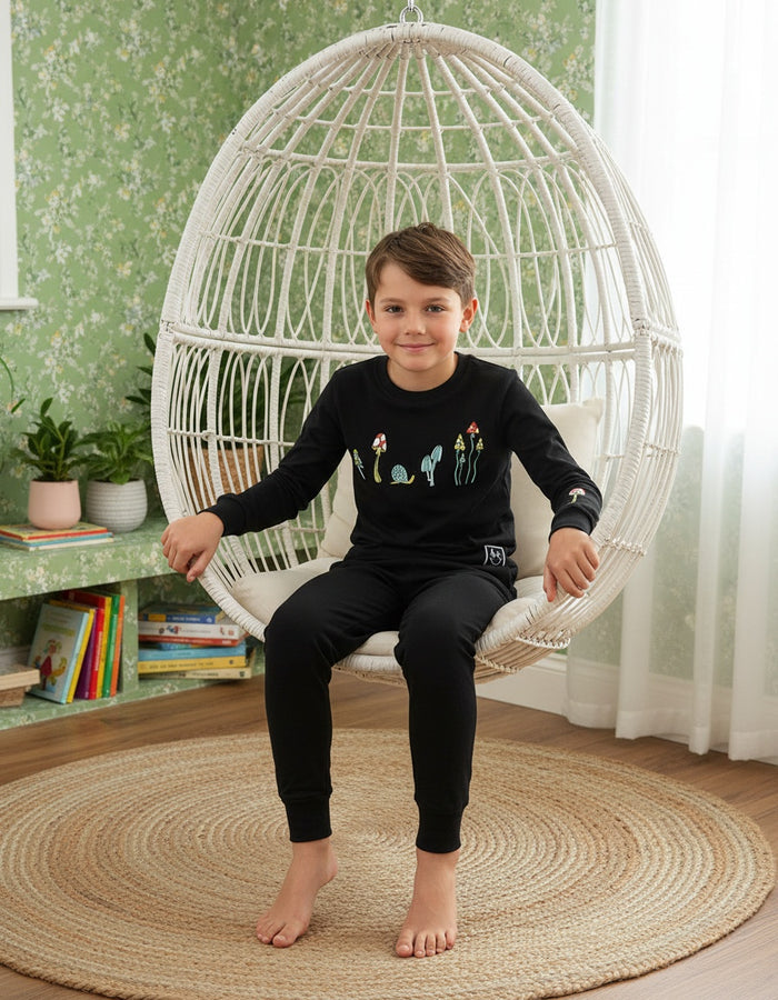 Kids black long-sleeve pajama set with colorful mushroom scene, matching jogger pants