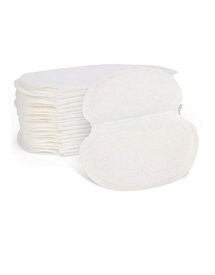 Stack of disposable underarm sweat pads, white oval pads with adhesive edges