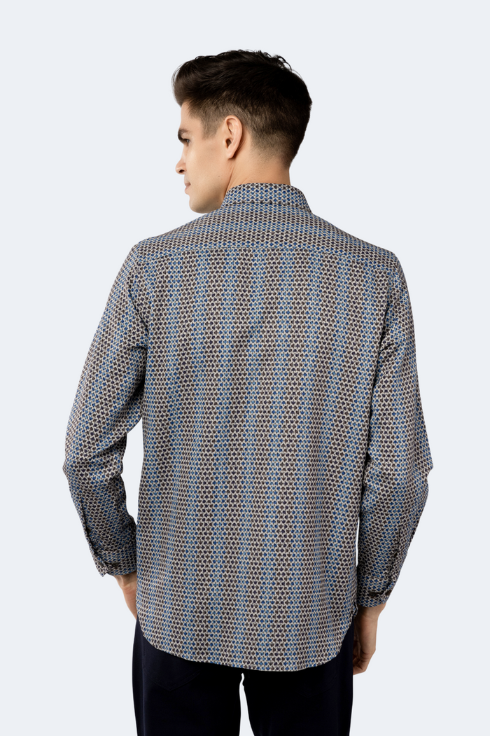 Man wearing a patterned shirt on a white background