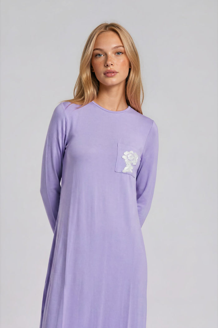 Pull on lilac nightgown with pocket and embroidered floral motif.