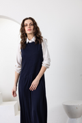Navy sleeveless long jumper with diagonal panel seams and straight skirt