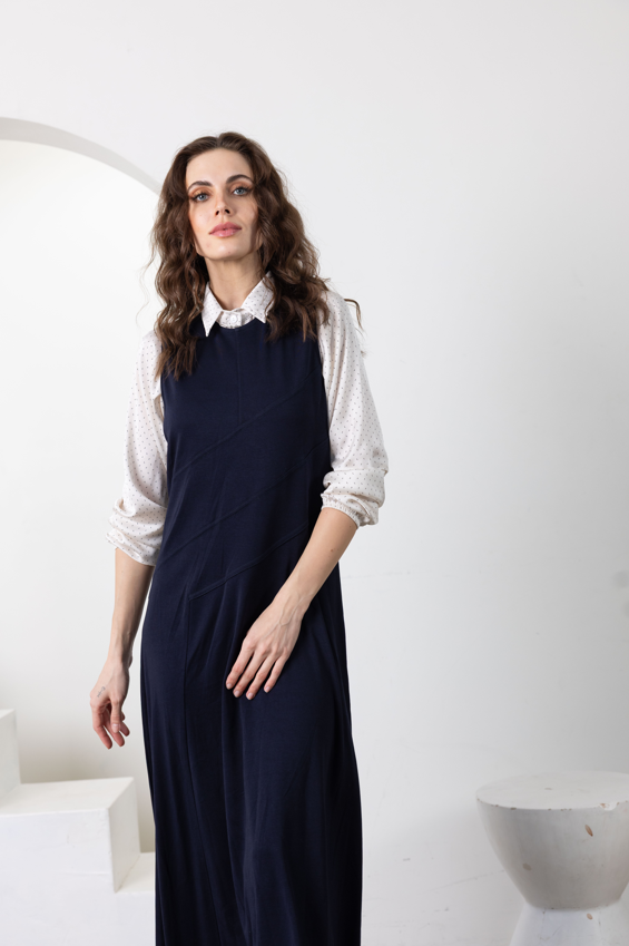 Navy sleeveless long jumper with diagonal panel seams and straight skirt