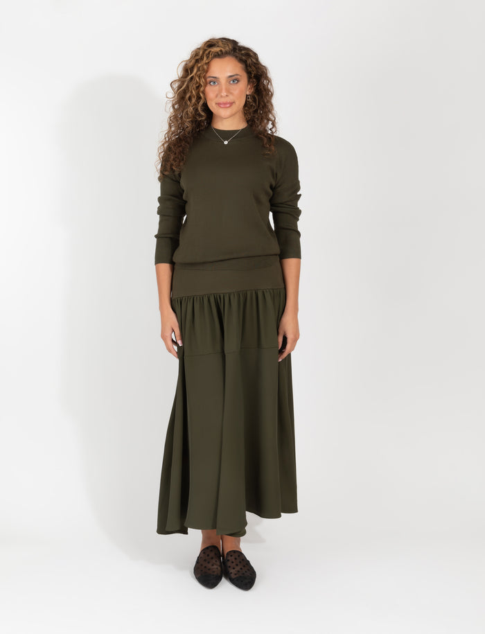 Olive two-piece set with fitted long-sleeve sweater and flowing midi skirt