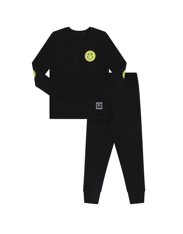 Boys black long-sleeve pajama set with green chest patch and matching pants, flat