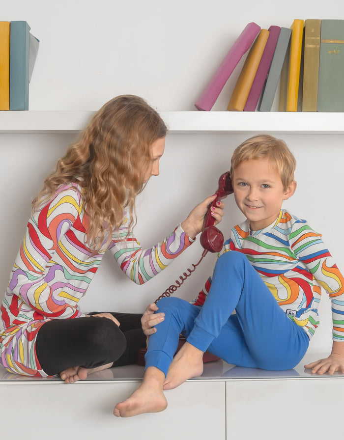 Kids pajama set worn: long-sleeve multicolor print tunic with blue leggings