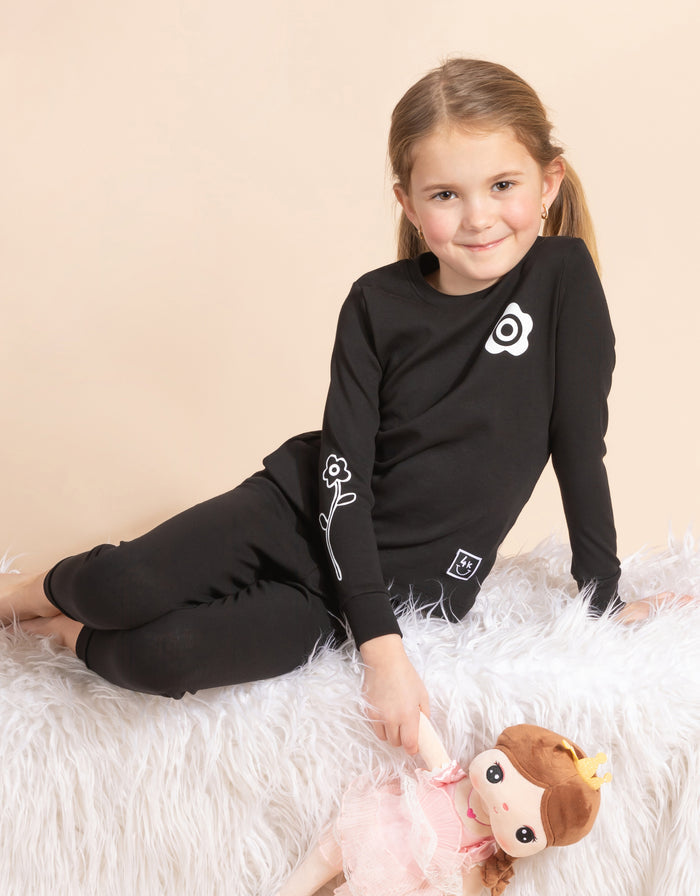 Black kids pajama set with long-sleeve top and leggings, daisy print details