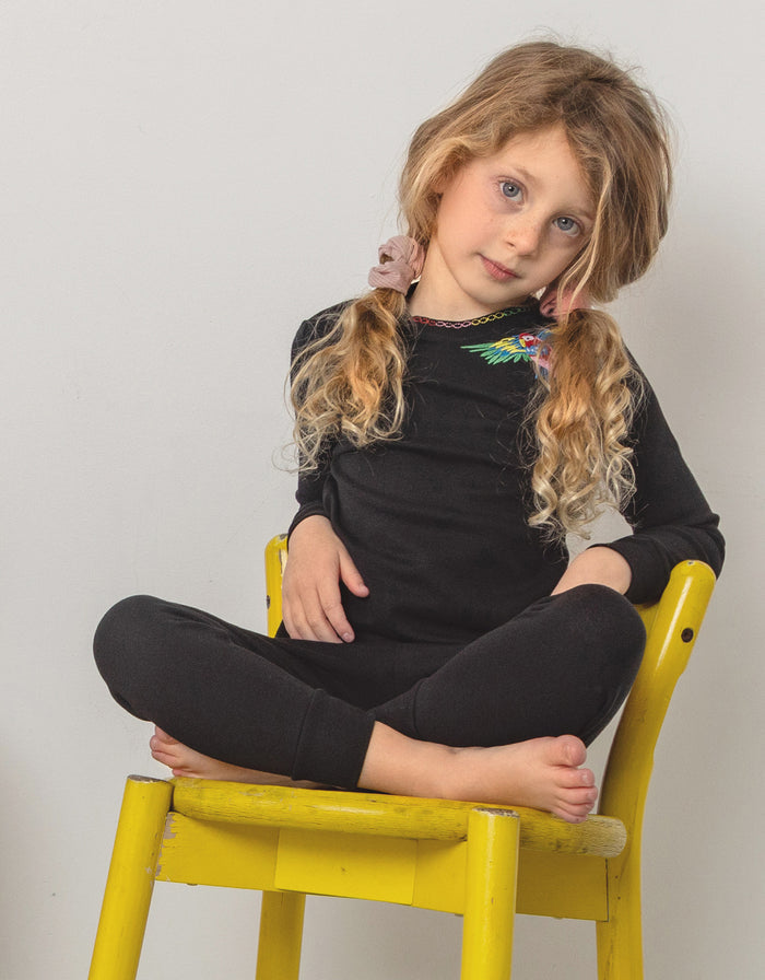 Kids black long-sleeve pajama set with colorful bird graphic; matching leggings