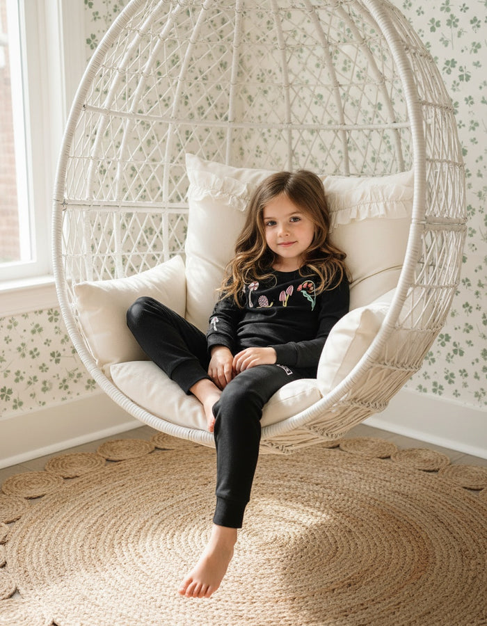 Girls' black long-sleeve pajama set with colorful character graphic and leggings