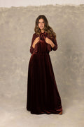 Burgundy velvet maxi dress with neck tie bow and matching knit cardigan.