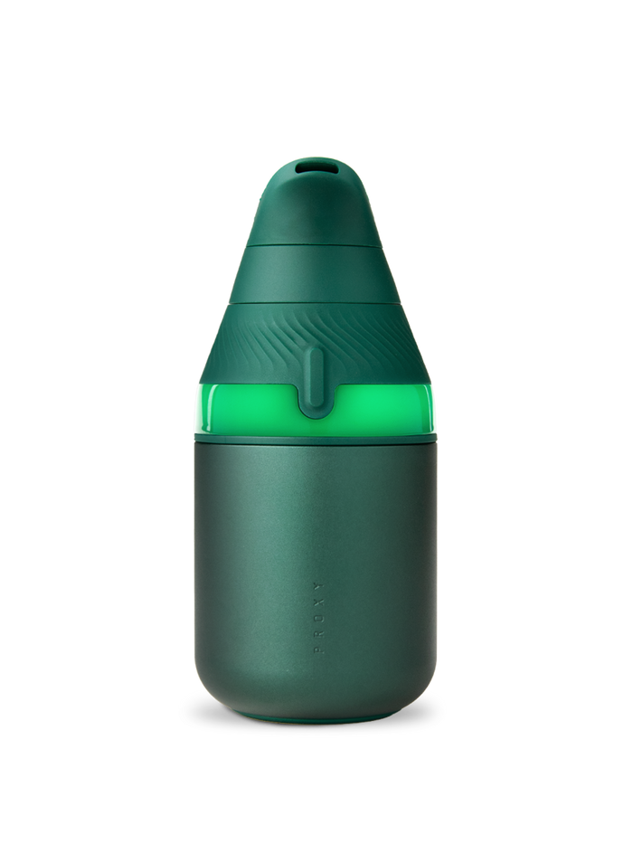 Pine Puffco Proxy Core vaporizer powered on with glowing green light band and matte body