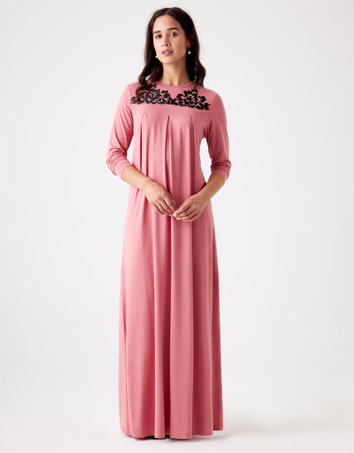 Pink pull-on pleated nightgown with black lace-trimmed neckline and long sleeves