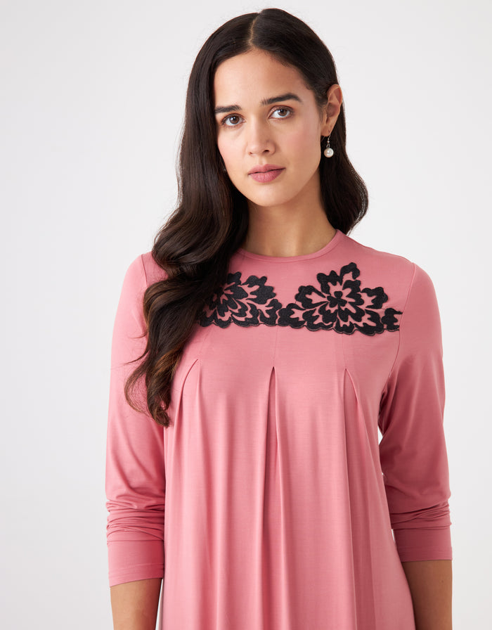 Pink pull-on pleated nightgown with black lace neckline detail and long sleeves