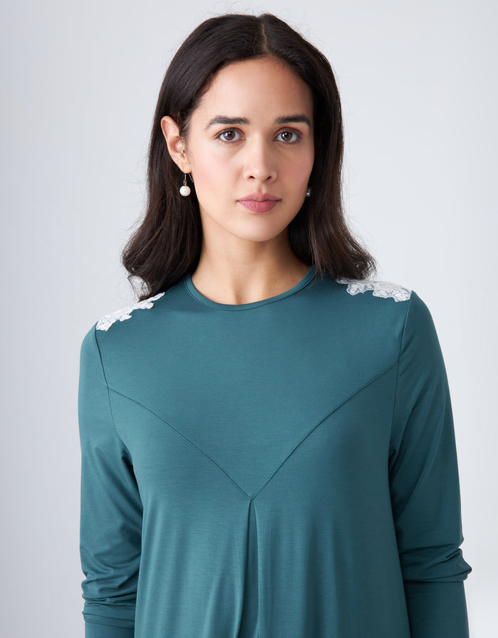 Teal nightgown close-up with V-cut bust seam and white lace trim at shoulders